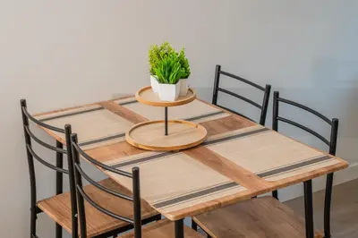 a wooden table with two chairs and a potted plant on it at Downtown Center Silverstone Tower I and II Home in Vancouver in Vancouver