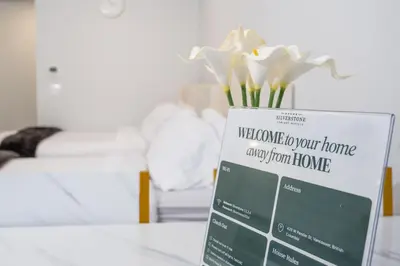 a sign on a table with flowers in a room at Downtown Center Silverstone Tower I and II Home in Vancouver in Vancouver