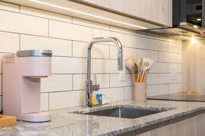 a kitchen counter with a sink and a mixer at Downtown Center Silverstone Tower I and II Home in Vancouver in Vancouver