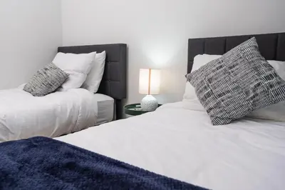 a bedroom with two beds with white sheets and pillows at Downtown Center Silverstone Tower I and II Home in Vancouver in Vancouver