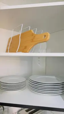 a shelf with plates and a wooden spoon on top at Sylvan Lake Retreat I 122A Hinshaw Drive, Sylvan Lake in Sylvan Lake