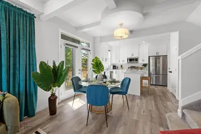 a kitchen and dining room with a table and chairs at Jungle House, AirCon, Sleeps 8, Near WEM & DT! in Edmonton