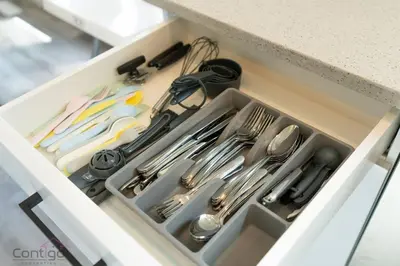 a drawer in a kitchen with utensils at Urban Jungle Getaway, AirCon, 10min to DT & WEM! in Edmonton