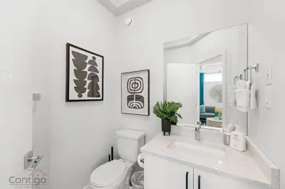 a white bathroom with a toilet and a sink at Urban Jungle Getaway, AirCon, 10min to DT & WEM! in Edmonton