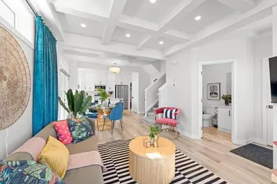 a living room with a couch and a table at Urban Jungle Getaway, AirCon, 10min to DT & WEM! in Edmonton