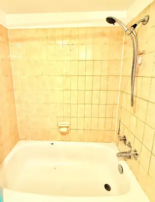 a bath tub in a bathroom with a shower at Private Room In The Heart Of The City in Vancouver