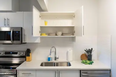 a kitchen with a sink and a microwave at The Den, Centrally Located Suite, King Bed, WiFi! in Edmonton
