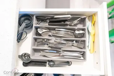 a drawer full of utensils in a white container at The Den, Centrally Located Suite, King Bed, WiFi! in Edmonton