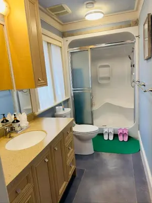 a bathroom with a toilet and a shower and a sink at Unitrip King bed in Richmond