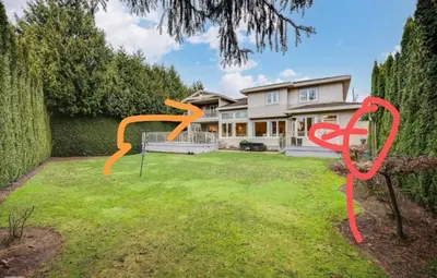 a house with a yard with orange sculptures on the grass at Unitrip King bed in Richmond