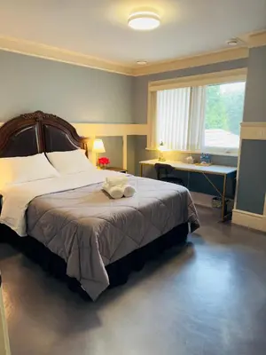 a bedroom with a large bed and a window at Unitrip Queen bed Room 2 in Richmond