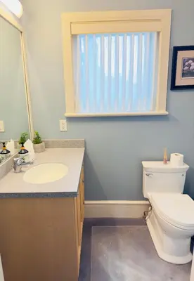 a bathroom with a toilet and a sink and a window at Unitrip Queen bed Room 2 in Richmond