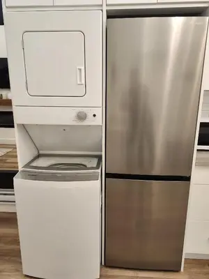 a stainless steel refrigerator in a kitchen with a printer at 2BR Detached Guesthouse - Free Parking -10 mins to YVR & Downtown in Vancouver