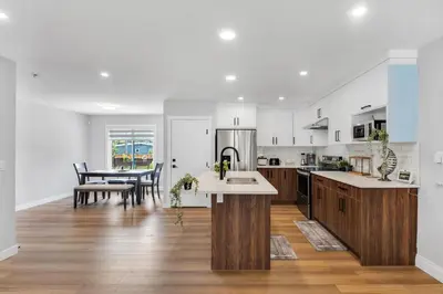 a kitchen and dining room with a table in it at Your stay at Haysboro in Calgary
