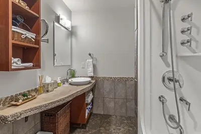 a bathroom with a sink and a shower at Luxury Rockies Retreat 1BR with Views in Canmore