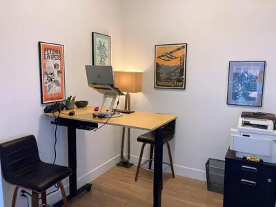 a desk with a computer and a chair in a room at The Bohemian, min 30-Day Stay with Breathtaking Views and Home Office by Victoria Prime! in Victoria