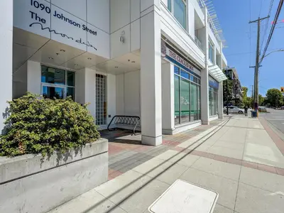 a building on a street with a sidewalk at The Bohemian, min 30-Day Stay with Breathtaking Views and Home Office by Victoria Prime! in Victoria