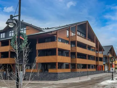 an apartment building with wooden balconies at Le Bucheron Stunning Spring Creek Luxury condo in Canmore