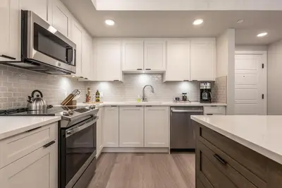 a white kitchen with white cabinets and appliances at Serenity at Sparrowhawk Lodge Brand New 2Bd 2Ba in Dead Man's Flats