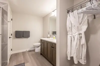 a bathroom with white towels hanging on a rack at Serenity at Sparrowhawk Lodge Brand New 2Bd 2Ba in Dead Man's Flats