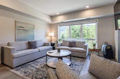 a living room with two couches and a table at Serenity at Sparrowhawk Lodge Brand New 2Bd 2Ba in Dead Man's Flats