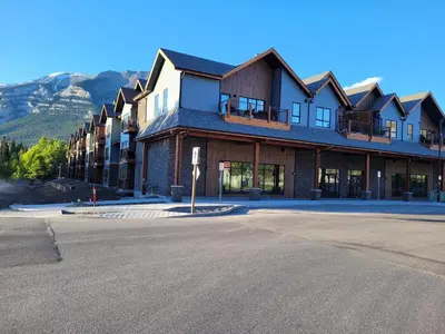 an empty street in front of a large building at Serenity at Sparrowhawk Lodge Brand New 2Bd 2Ba in Dead Man's Flats