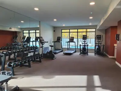 a gym with treadmills and machines in a room at Serenity at Sparrowhawk Lodge Brand New 2Bd 2Ba in Dead Man's Flats