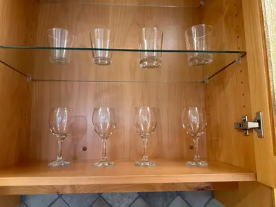 a row of wine glasses sitting on a shelf at Upper floor suite with Garden view near SFU & Skytrain in Coquitlam