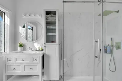 a white bathroom with a shower and a sink at ModernOasis with AC&MovieRoom close to Downtown15' Banff 60' in Calgary