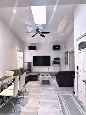 a living room with a couch and a flat screen tv at The warm and lovely coach home in Vancouver