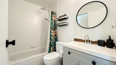 a bathroom with a sink and a toilet and a mirror at Stunning 1-Bedroom Condo in the Heart of Vancouver in Vancouver