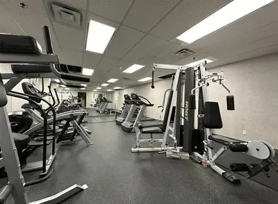 a gym with several treadmills and machines in it at Stunning 1-Bedroom Condo in the Heart of Vancouver in Vancouver
