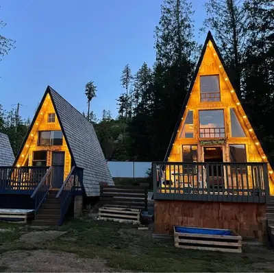 a large log cabin with a deck and a house at Oysterbeds offers our Oyster Suite in Lund