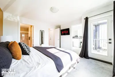 a bedroom with a large bed and a window at Modern Retreat - 3 King Beds - Garage - WiFi - Sleeps 10 in Edmonton