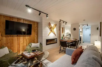 a living room with a couch and a table at Powder & Pines Boutique Apartment in Whistler