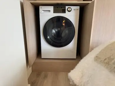 a washer and dryer sitting in a room at Skywood-Designer Condo,Steps to Creekside Gondola, Free Parking in Whistler