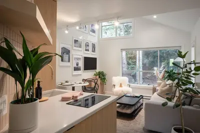 a living room with a couch and a table at Skywood-Designer Condo,Steps to Creekside Gondola, Free Parking in Whistler