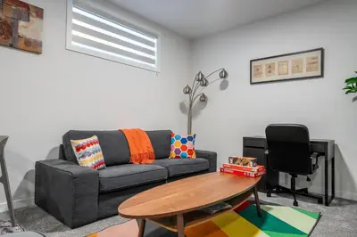 a living room with a couch and a table at Perfect Stay 2 Bedroom Basement Suite in Airdrie