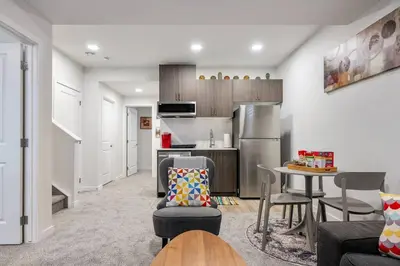 a living room with a kitchen and a dining room at Perfect Stay 2 Bedroom Basement Suite in Airdrie