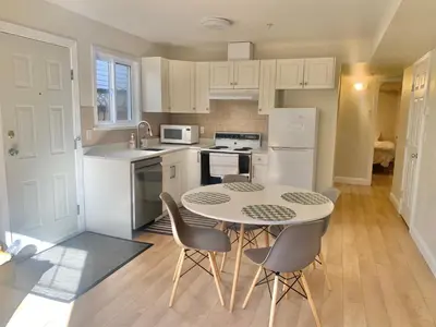 a kitchen with a table and chairs in a room at Entire 1Bed 1Bath Suite Coquitlam Centre in Port Coquitlam