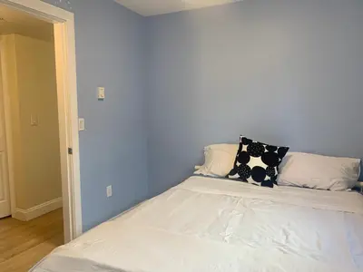 a bed with two pillows on top of it at Entire 1Bed 1Bath Suite Coquitlam Centre in Port Coquitlam