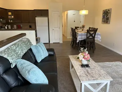 a living room with a couch and a table at 4br Crew House - Big, Bright, Modern, Fully Stocked in Grande Prairie