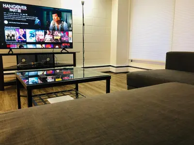 a living room with a couch and a tv at 5th Floor 1 Bedroom Condo with Parking in Calgary
