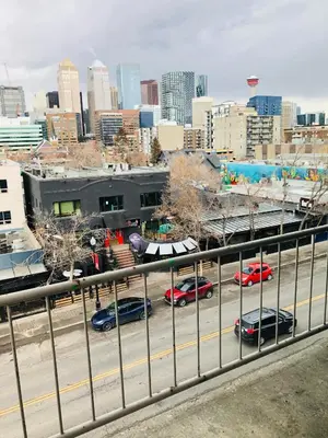 a city skyline with cars parked in a parking lot at 5th Floor 1 Bedroom Condo with Parking in Calgary