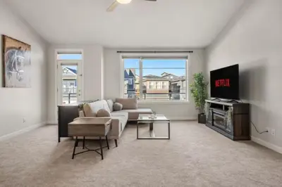 a living room with a couch and a tv at 3 Bedroom Sage House with AC, Driveway Parking, King Bed & More in Calgary