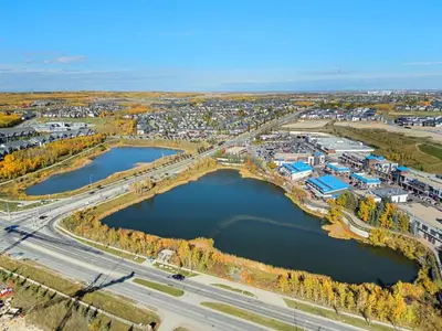 an aerial view of a city with two reservoirs at Aspen - Town House with 2 Bedrooms, Garage Parking, AC & More! in Calgary
