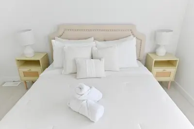 a bedroom with a bed with towels on it at Luxury 3 Bdrm 3 Bath townhome in Chestermere in Chestermere