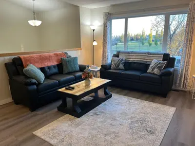 a living room with two couches and a coffee table at Park View Paradise - Big, Bright, Modern, Fully Stocked in Grande Prairie
