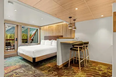 a hotel room with a bed and a table and chairs at Otter Hotel in Banff