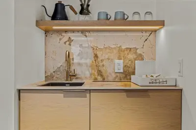 a kitchen with a sink and a counter top at Otter Hotel in Banff